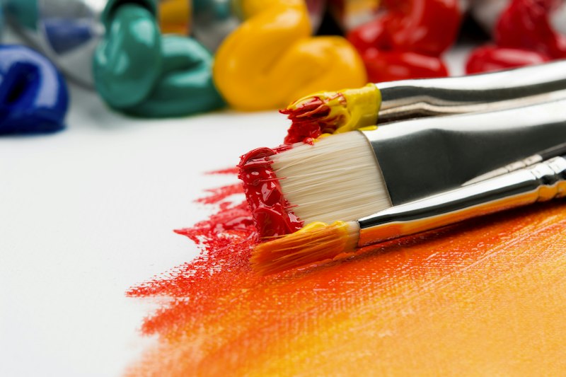 Artist painting mural with pigments